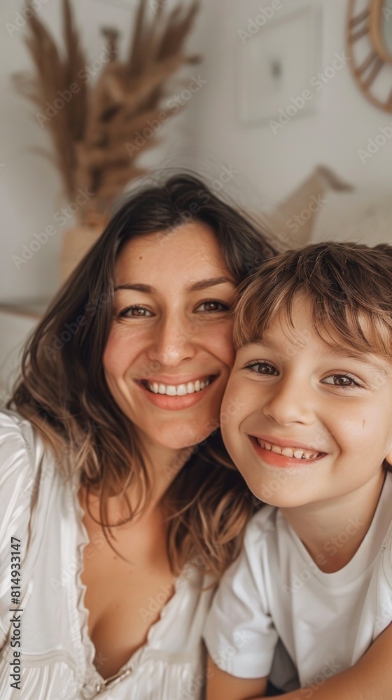 A mother and child sharing a joyful moment their smiles radiating warmth and love in a cozy well-decorated room. A mother and child sharing a joyful moment their smiles radiating warmth and love in a cozy well-decorated room.