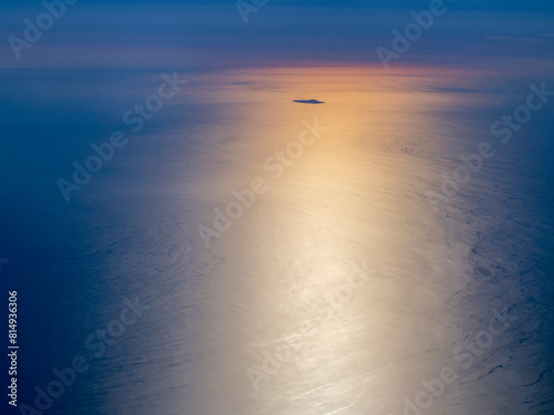 Ustica island aerial view from airplane at golden sunset, while flying over Aeolian Islands, Sicily, Italy photo