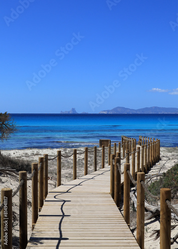 Footbridge on a sandy beach in Formentera with a wiew on Es Vedrà – Ibiza