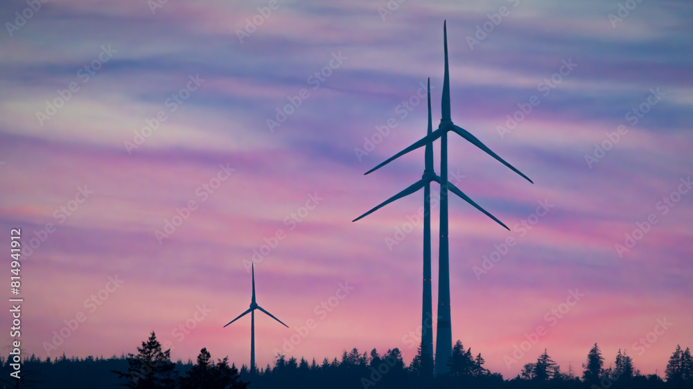 Wind turbines in the countryside in front of the colorful sky at dawn Wind turbines in the countryside in front of the colorful sky at dawn
