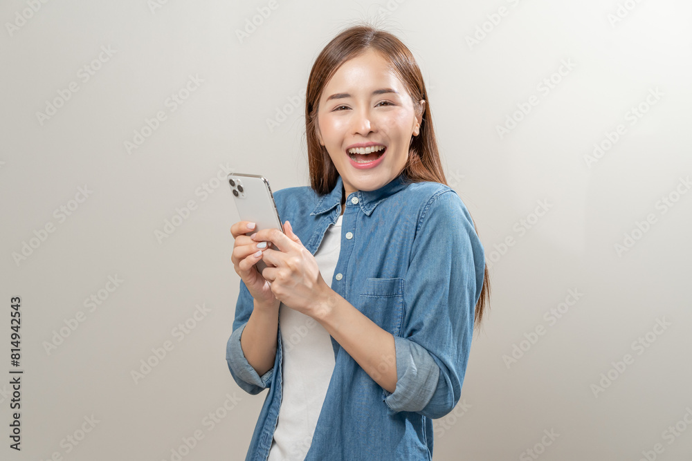 Happy Asian woman holding a smartphone and winning the prize. Happy Asian woman holding a smartphone and winning the prize.