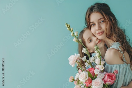Happy woman with her daughter and bouquet of beautiful photo