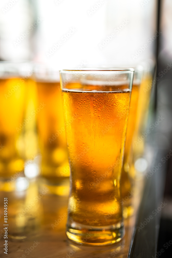 Amber lager beer in glasswares which are prepared for the party event. Refreshment drinking, close-up and selective focus. Amber lager beer in glasswares which are prepared for the party event. Refreshment drinking, close-up and selective focus.