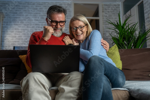 Overjoyed mature man and woman triumph win online lottery on laptop. Happy excited senior Caucasian couple feel euphoric with good email, get amazing sale offer or discount deal on computer.