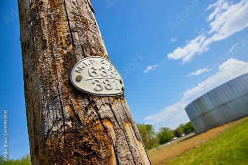 Weathered Utility Pole with ID Tag, Industrial Skyline, Upward View photo