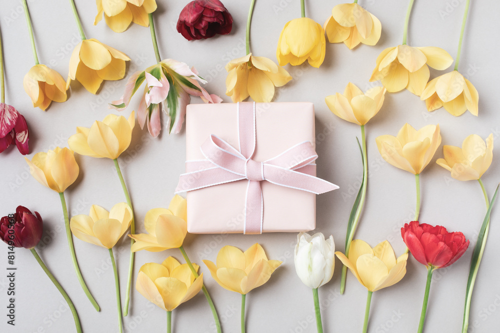 Beautiful aesthetic composition with gift box and flowers on neutral beige background. Greeting card in modern style. Beautiful aesthetic composition with gift box and flowers on neutral beige background. Greeting card in modern style.