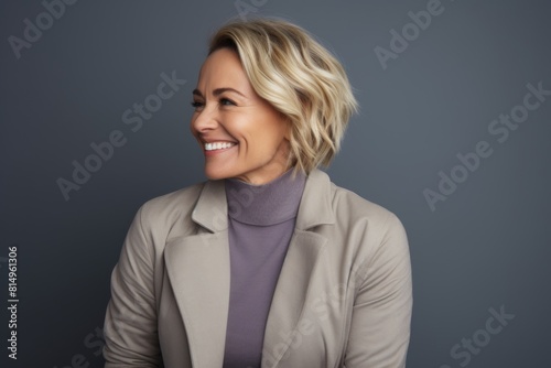 Portrait of a cheerful woman in her 40s with arms crossed on pastel purple background