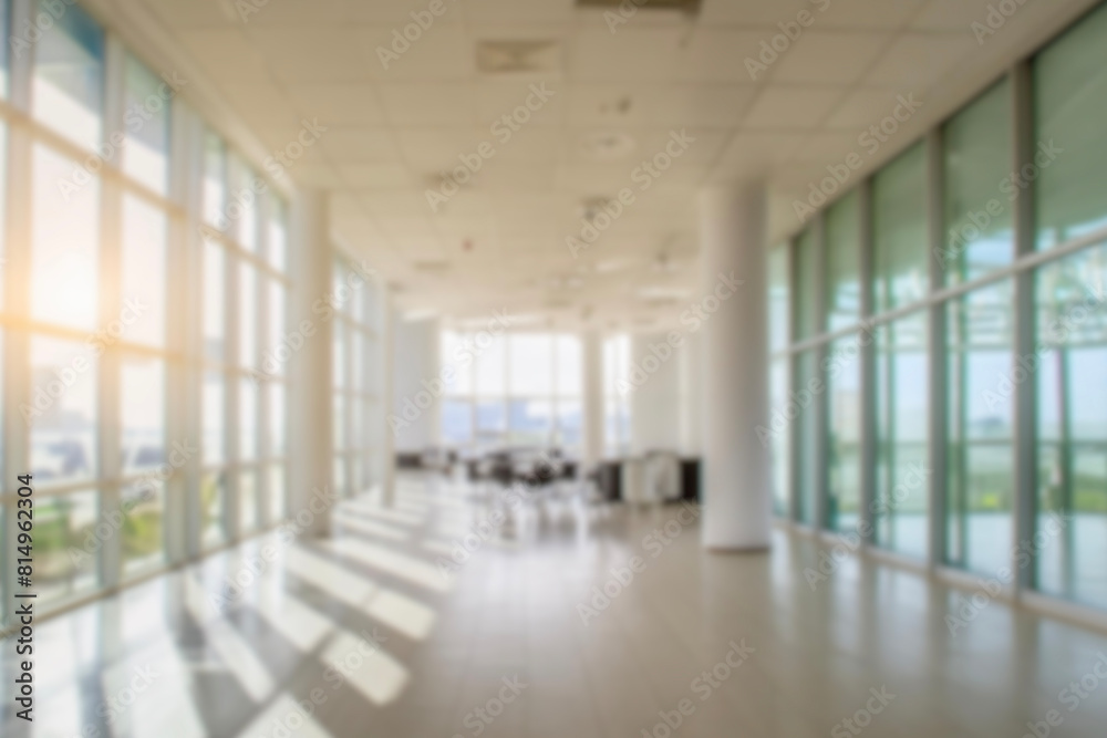 Fototapeta premium blurred for background. office building interior, empty hall in the modern office building. empty open space office. panoramic windows and beautiful lighting