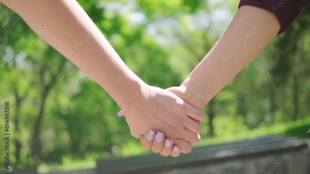 Close up female couple holding hands, lesbians hands joining together Close up female couple holding hands, lesbians hands joining together