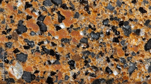  A tight shot of a granite countertop showcases orange and black specks interspersed among white ones