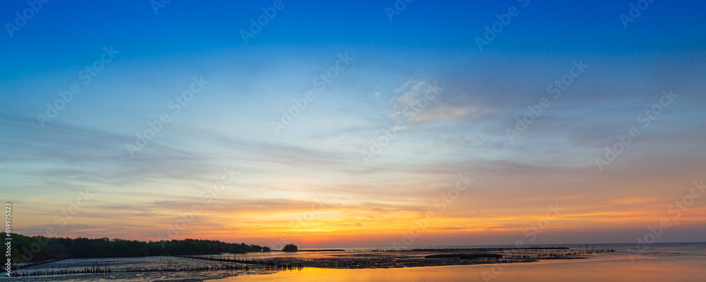 Fototapeta premium Clouds and orange sky,Real majestic sunrise sunset sky background with gentle colorful clouds without birds.Panorama, large