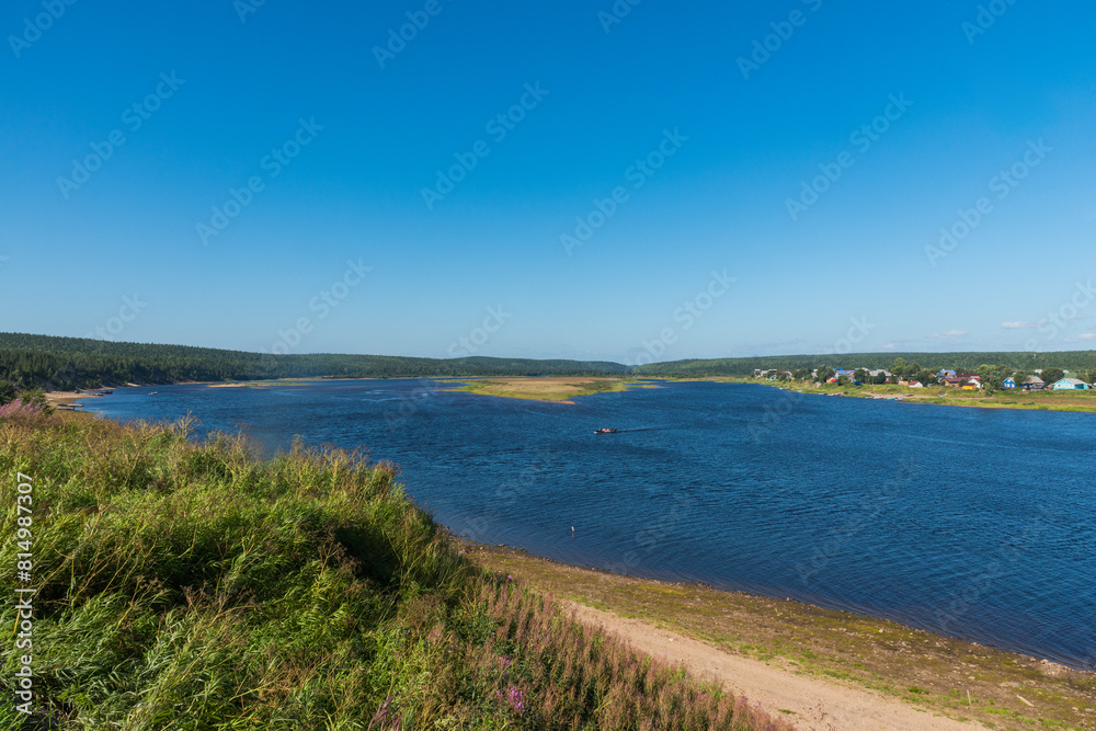 panoramic view of the wide river and the village on the other side