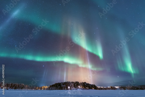 Light pillars and northern lights in the sky photo