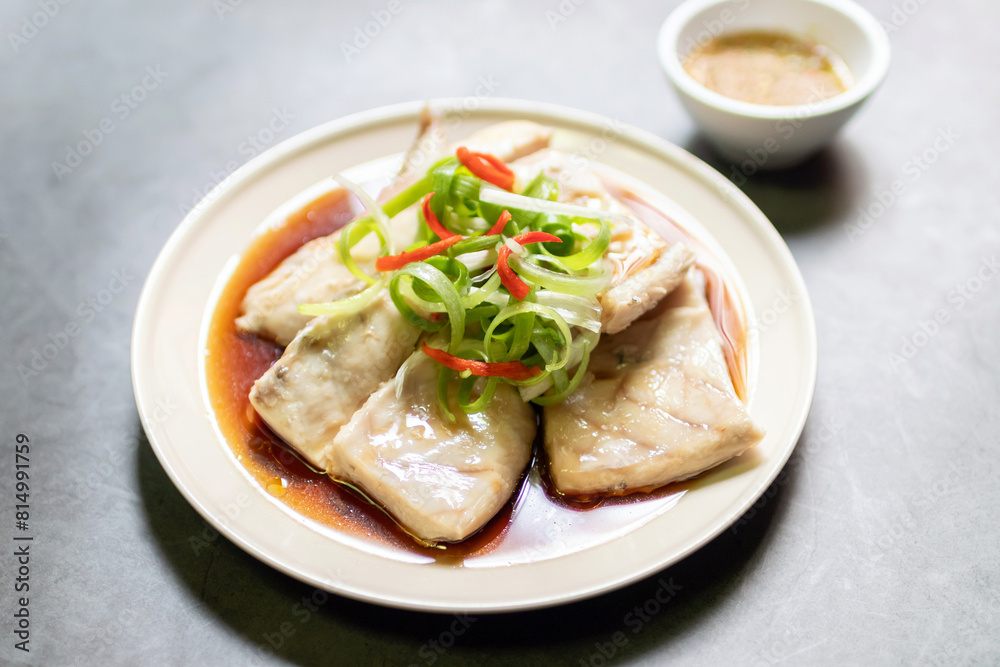 Sea bass fillet steam with soy sauce. Top view on black table background. Sea bass fillet steam with soy sauce. Top view on black table background.