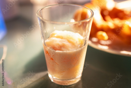 Soft-boiled eggs in glass with seasoning sauce and ground pepper  Thai breakfast vintage style.