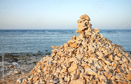 Pyramid of coral and stones on the beach, selective focus, Egypt.