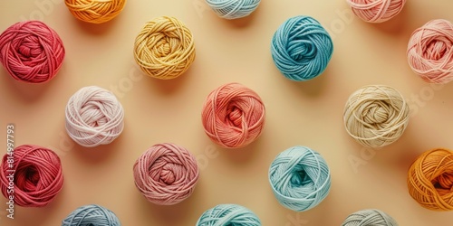 top view of colorful yarn balls on beige background, flat lay