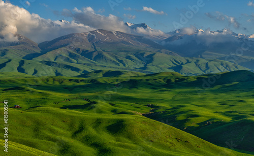 A picturesque plateau against the backdrop of snow-covered peaks in the Trans-Ili Alatau (Kazakhstan)