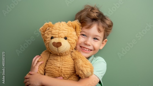Boy embracing his teddy bear photo