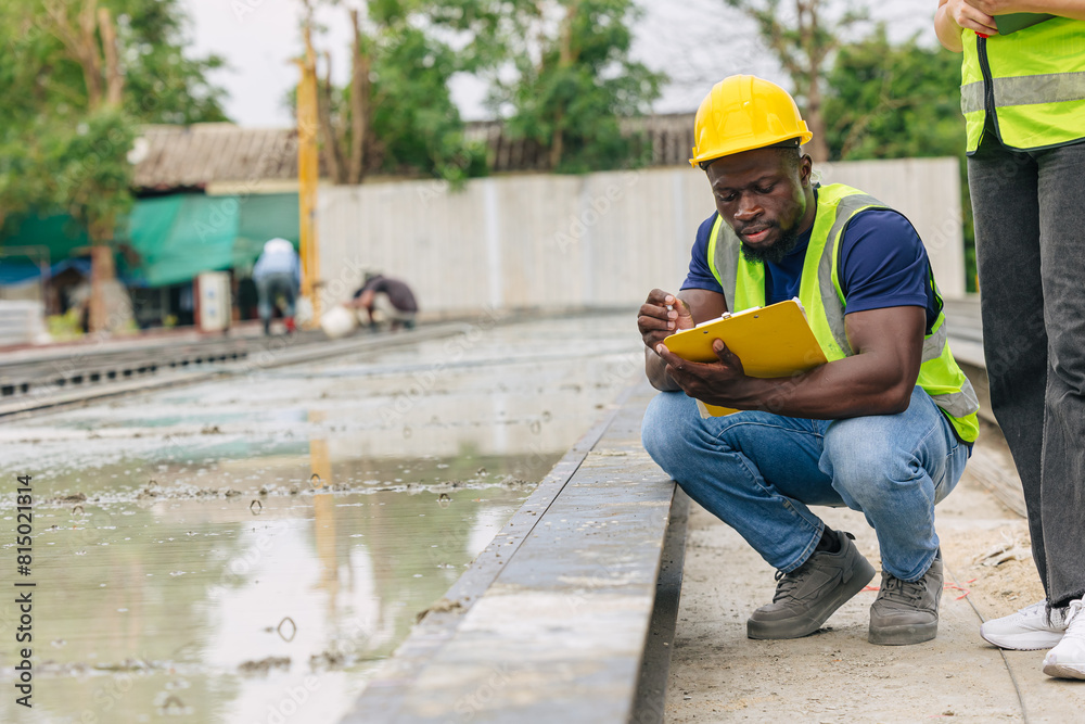 Obraz premium African black engineer worker working in Precast concrete casting manufacturing checking product quality standard outdoor construction site