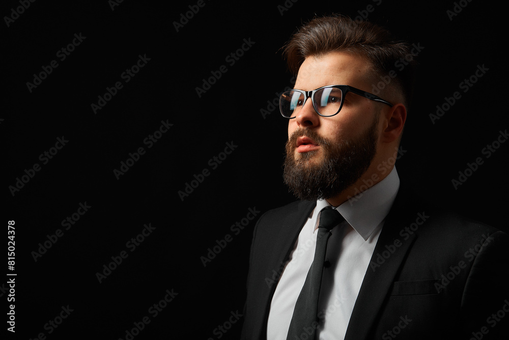 Portrait of a successful businessman on a black background. Grain effect used Portrait of a successful businessman on a black background. Grain effect used