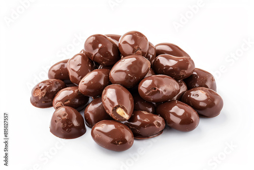 a pile of chocolate covered olives on a white surface