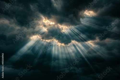 A dark sky with rays streaming through the clouds