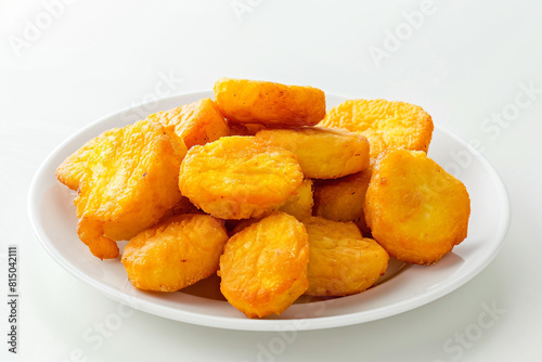 a plate of fried bananas on a white table