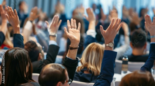In a conference and convention at a corporate event businesspeople raise their hands to ask questions and vote. The meeting training seminar and discussions emphasize teamwork and collaboration.