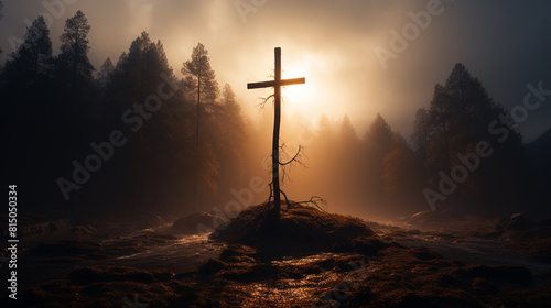 Silhouettes of crucifix symbol on top mountain with bright sunbeam on the colorful sky background