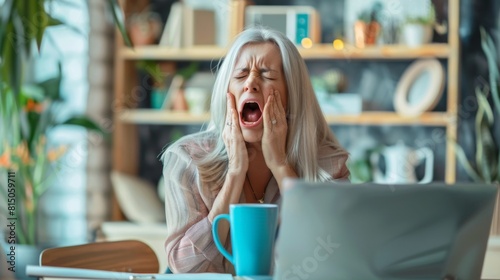 A Woman Yawning at Her Desk photo