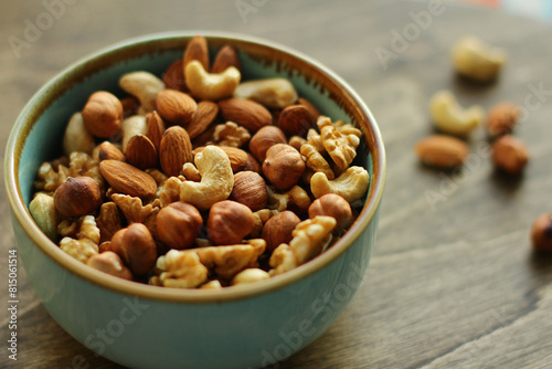 a plate of nuts. a nutritious and healthy snack. A mixture of walnuts, almonds, hazelnuts, cashews. Vegetarian food
