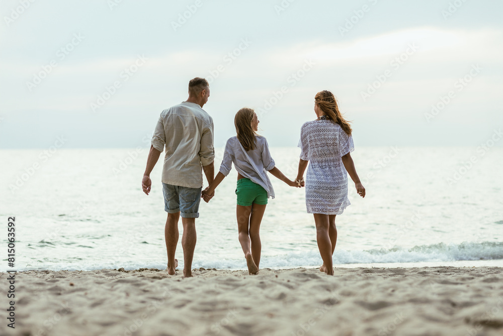 Family Walking on Beach Holding Hands