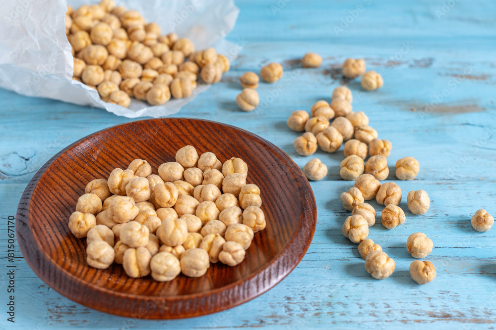 Crispy Roasted Chickpeas on wooden background. Healthy snack. Crispy Roasted Chickpeas on wooden background. Healthy snack.