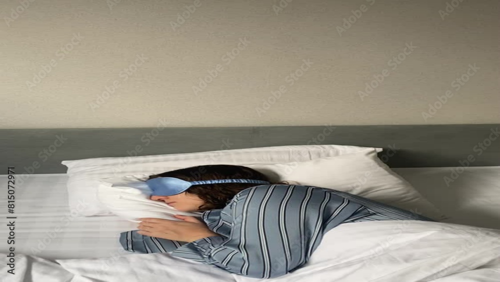 young woman sleeps in a sleep mask, sinks her face into the pillow young woman sleeps in a sleep mask, sinks her face into the pillow