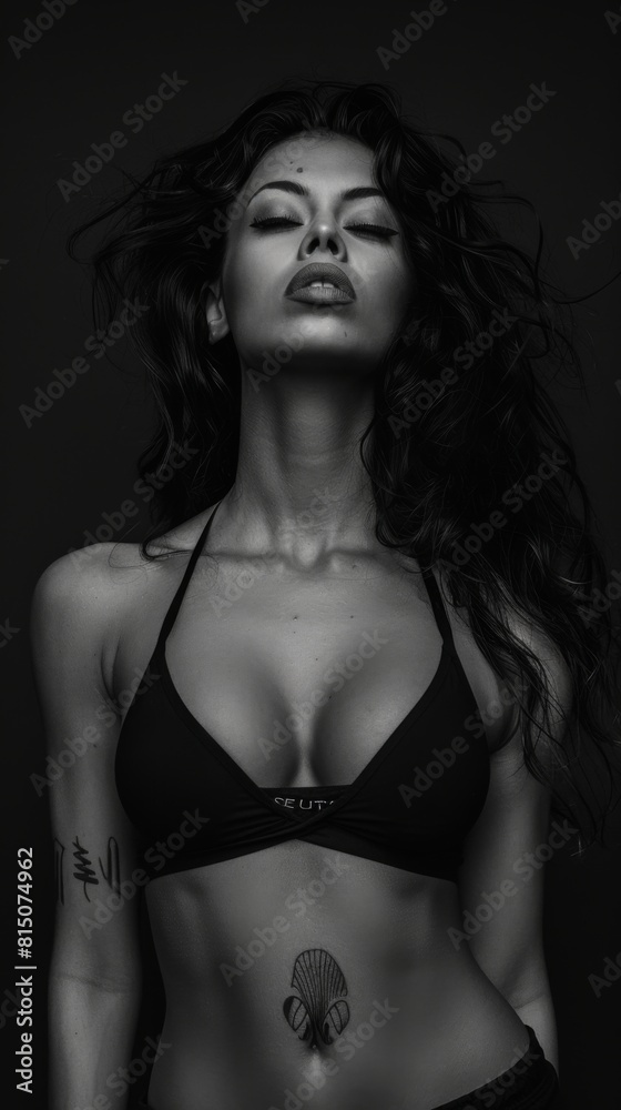 A fit woman in a bikini poses elegantly in black and white A fit woman in a bikini poses elegantly in black and white