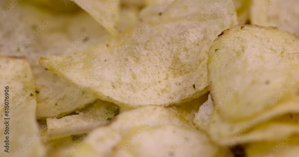 thin potato chips with spices, close-up of a pile of potato chips on the table thin potato chips with spices, close-up of a pile of potato chips on the table