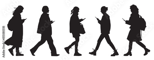 Black silhouettes of walking women using phones on the go. Side view. Isolated on white background. Vector illustration.