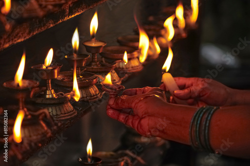 Lighting prayer candles in a Buddhist temple