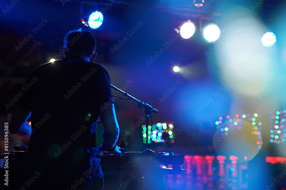 DJ performs in a nightclub at a party. DJ performs in a nightclub at a party.