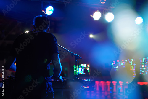 DJ performs in a nightclub at a party.