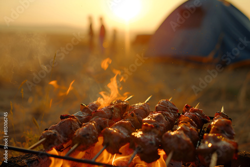 Skewers of meat are grilled on a barbecue at a camping picnic