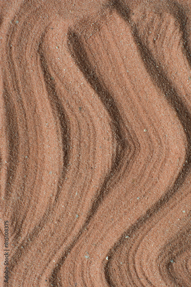 Lines drawn in brown sand background, beautiful sand texture, overhead view of chocolate brown sand, zen pattern drawn in the sand, Top view of fine grain texture