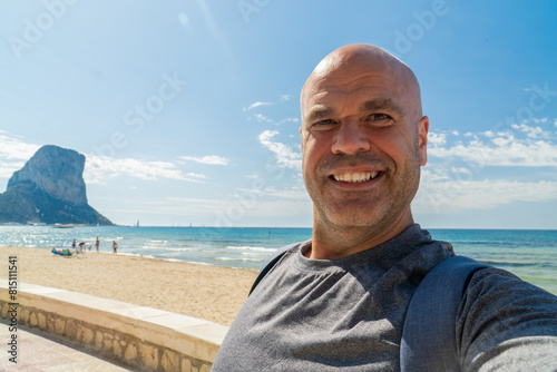 Male tourist takes a selfie on the beach, in Calpe, Alicante (Spain). 