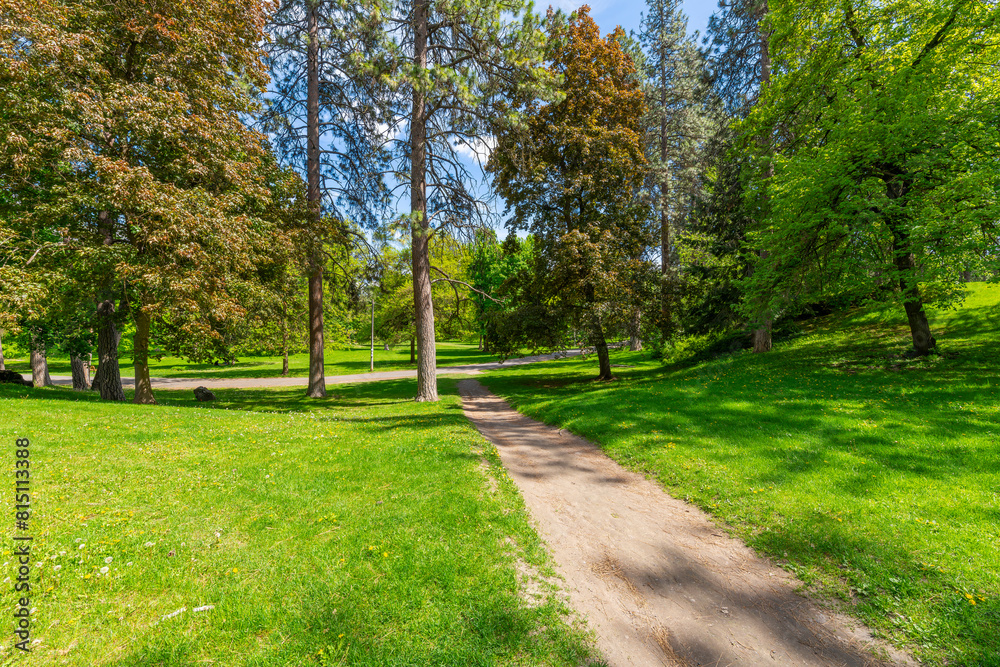 Trees, grass and walking paths at the central park area of the 90 acre Manito Park and Botanical Gardens in the South Hill district near downtown Spokane, Washington. Trees, grass and walking paths at the central park area of the 90 acre Manito Park and Botanical Gardens in the South Hill district near downtown Spokane, Washington.