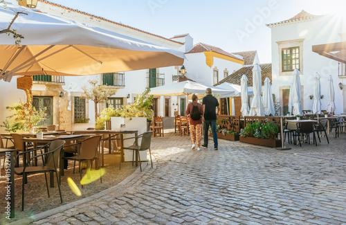 Algarve, Portugal - Tourist people walk on a old town streets at Faro