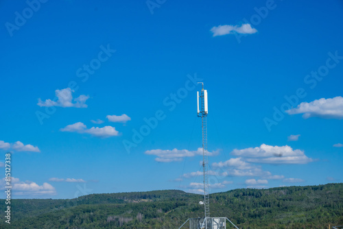 gray mast Telephone Signal tower which has a wireless telephone transceiver