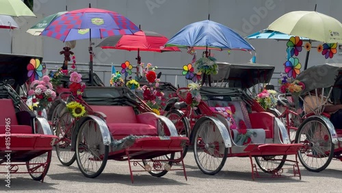 Trishaw bikes for public and tourist transport standing empty in front of the International Cruise Terminal, George Town, Penang, Malaysia photo