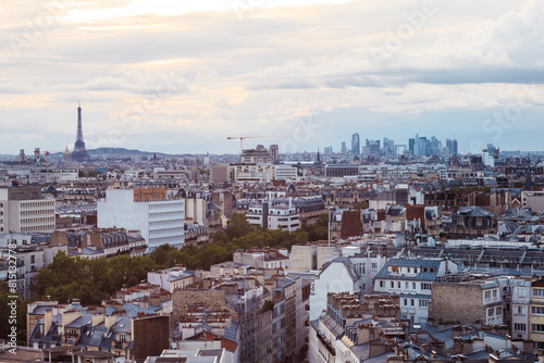 Paris cityscape with Eiffel Tower and defense district at sunset