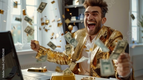 Young happy and successful funny man with golden suit sitting at desk, building business online using laptop, and throwing dollar bills to celebrate his success.